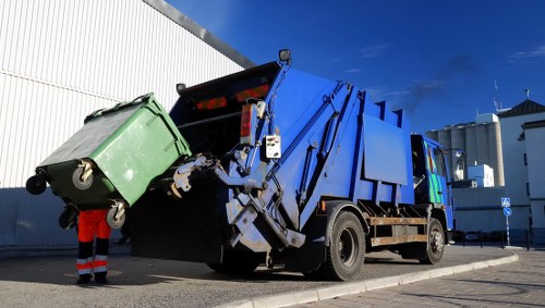 Cluttered garage being cleared by professionals